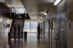 Men out of their cells on the induction wing for new prisoners at HMP Berwyn, a category C adult male prison operated by His Majesty’s Prison Service (HMPPS) is the largest jail in the UK, situated in Wrexham, Wales, United Kingdom. The prison is split into three house blocks holding general, remand and vulnerable prisoners with a capacity of 2106 inmates. (photo by Andy Aitchison)